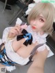 A woman in a maid outfit taking a selfie.