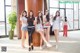 A group of young women posing for a picture in a hotel lobby.