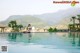 A woman sitting on the edge of a swimming pool.