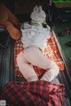 A woman laying on a blanket with a teddy bear.