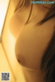 A close up of a woman's breasts in a mirror.