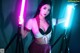 A woman holding two lightsabers in her hands.