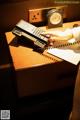 A person is using a telephone on a desk.