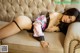 A woman laying on top of a couch in lingerie.