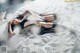 A woman laying on top of a bed in lingerie.