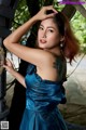 A woman in a blue dress posing for a picture.