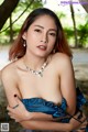 A woman in a blue dress posing for the camera.
