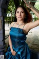 A woman in a blue dress posing for a picture.