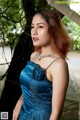 A woman in a blue dress posing for a picture.