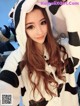 A woman in a cow costume posing for a picture.