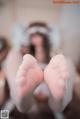 A close up of a person's feet in white stockings.