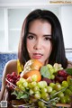 A woman holding a basket full of fruit in her hands.