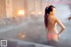 A woman in a bikini standing in a hot spring.