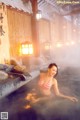 A woman in a bikini sitting in a hot tub.