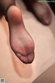 A close up of a person's feet in black stockings.